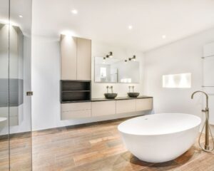 A modern bathroom with wooden floors and a large bathtub suitable for Bathroom Remodels in the city.