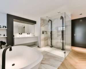 A modern bathroom with a glass shower in the city.