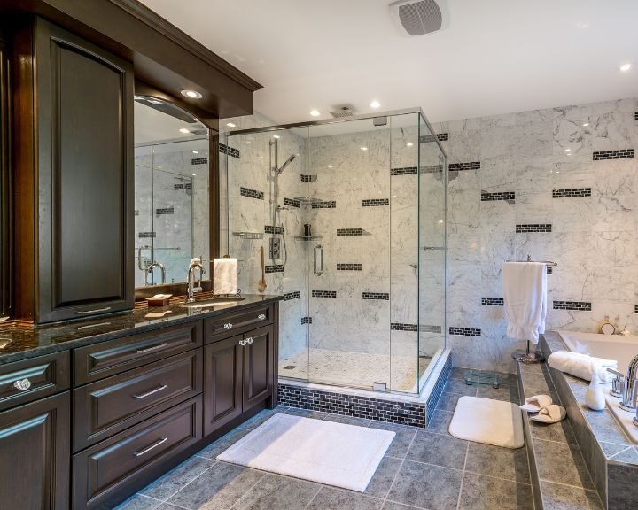A large bathroom with cabinets and a walk-in shower.