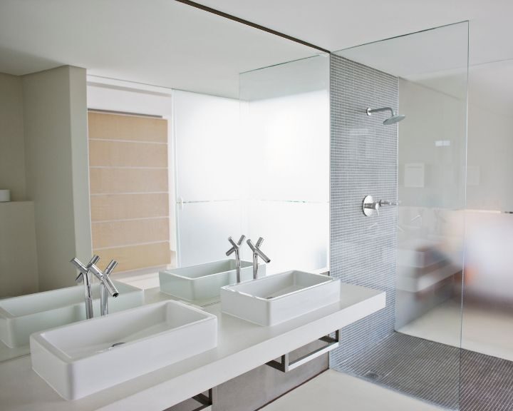 A modern bathroom with two sinks and contemporary countertops.