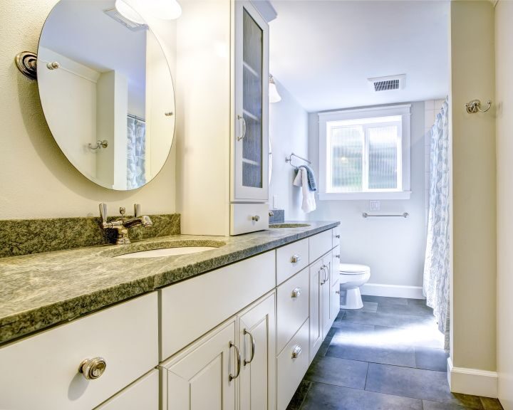A bathroom with granite countertops.