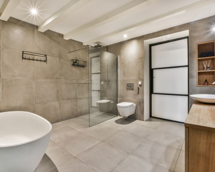 A modern bathroom with a renovated bathtub and shower in Waterbury.