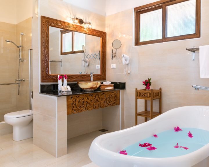 A bathroom design with a bathtub, sink and toilet.