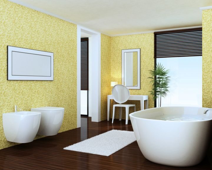 A bathroom design with a yellow color scheme and wooden flooring.