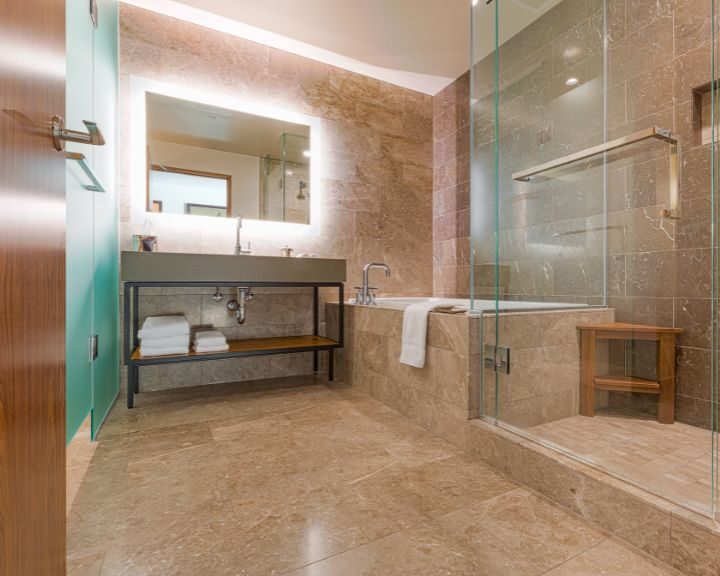 A city-inspired bathroom with glass shower and tile.