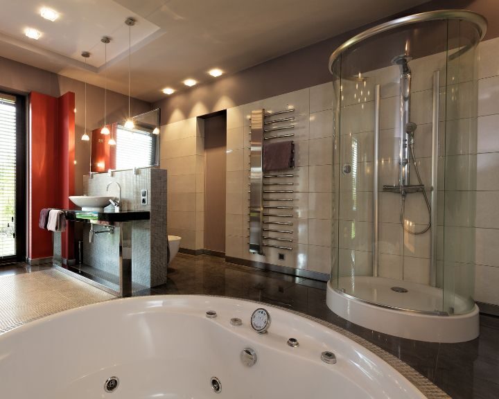 A modern bathroom with a glass shower stall and tub in the city.