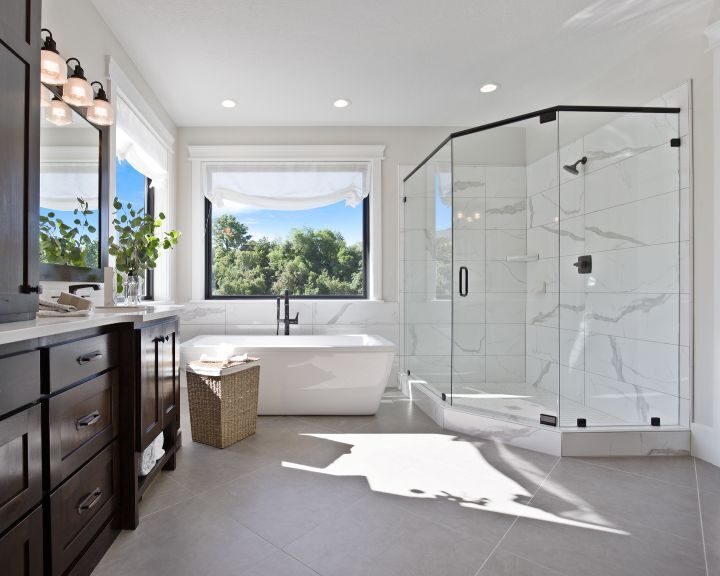 A modern bathroom with a large walk in shower.