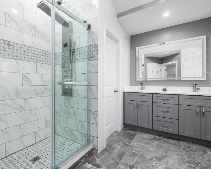 A white bathroom with a glass tub to shower.
