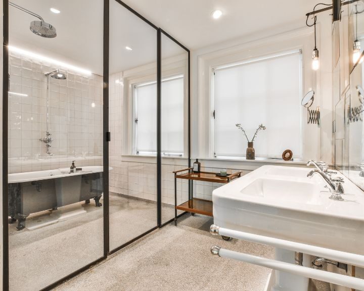 A bathroom with a glass shower enclosure.