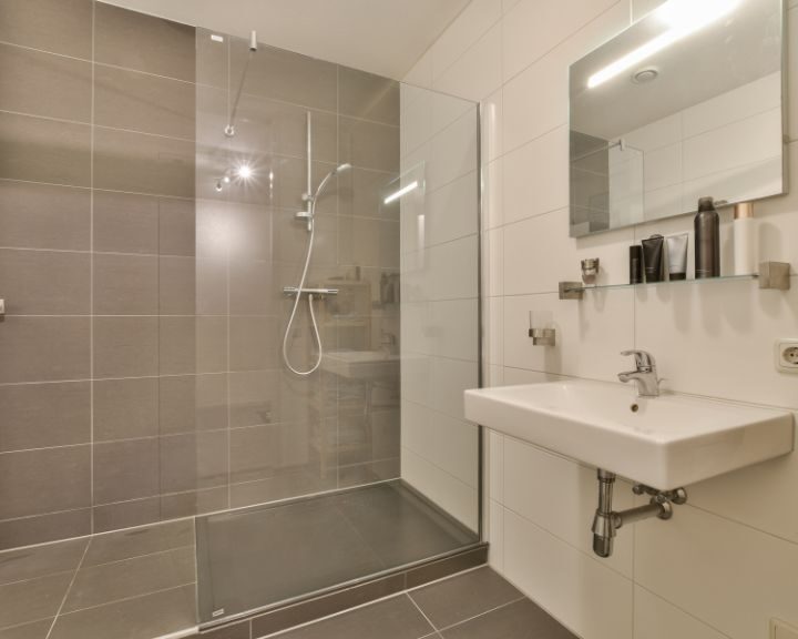 A bathroom in Waterbury with a shower stall and sink.