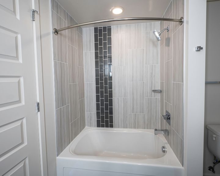 A bathroom with a tub and shower.